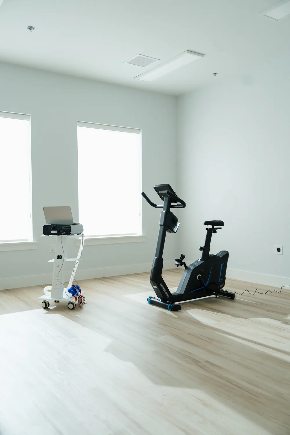 The VO2 max testing room at Highland Longevity in Fort Worth, with an exercise bike and a metabolic cart